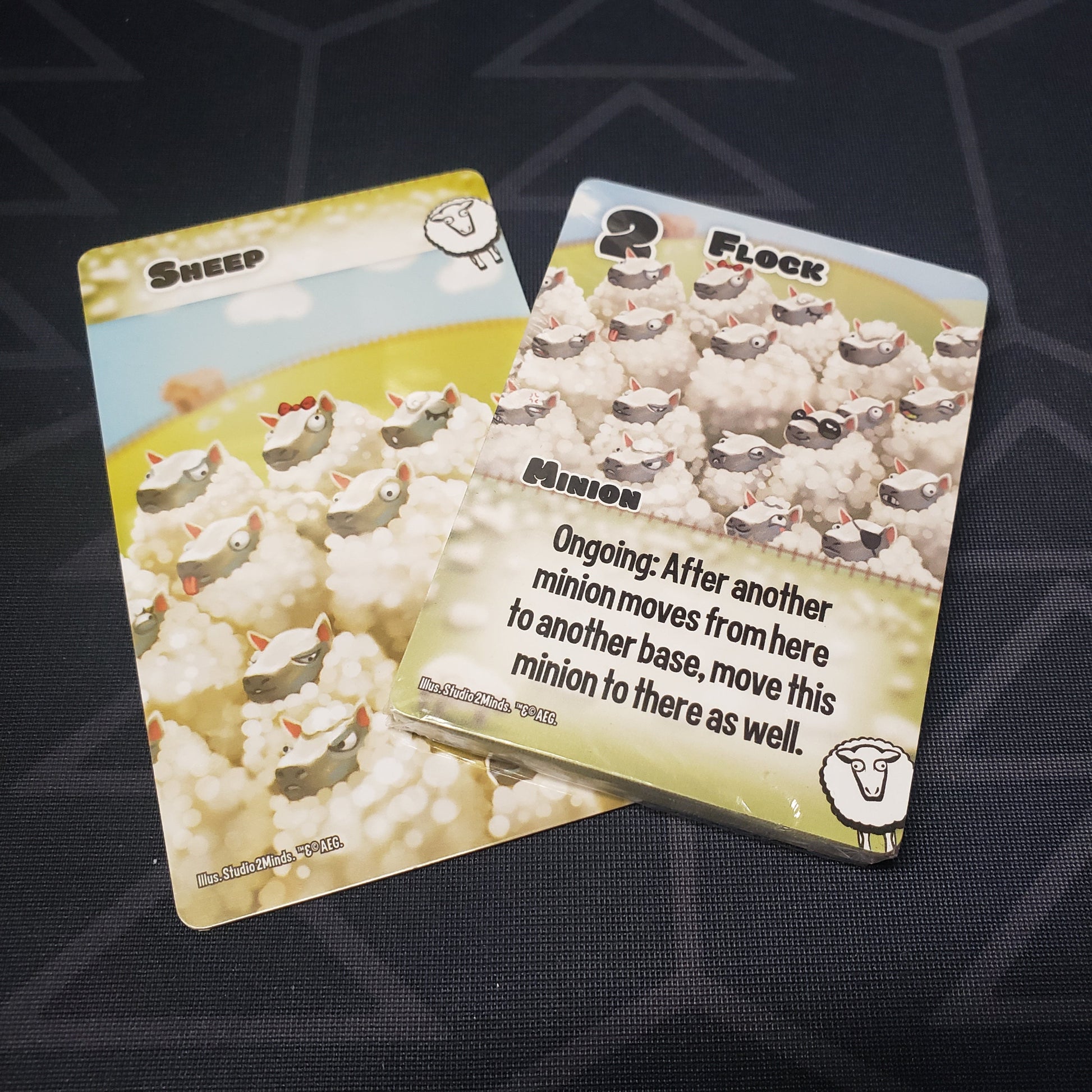 Image shows the sealed card deck and organizational divider of the Sheep expansion for the card game Smash Up