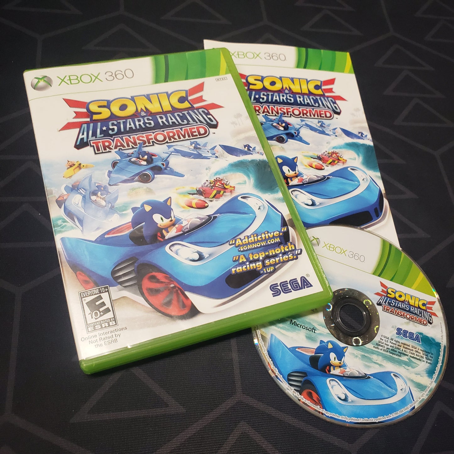 Image shows the case, manual and disc for the video game Sonic & All-Stars Racing Transformed for Xbox 360