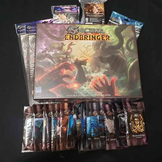 Image shows the box of the Endbringer expansion for the board game Sorcerer, surrounded by bonus Kickstarter expansion card packs