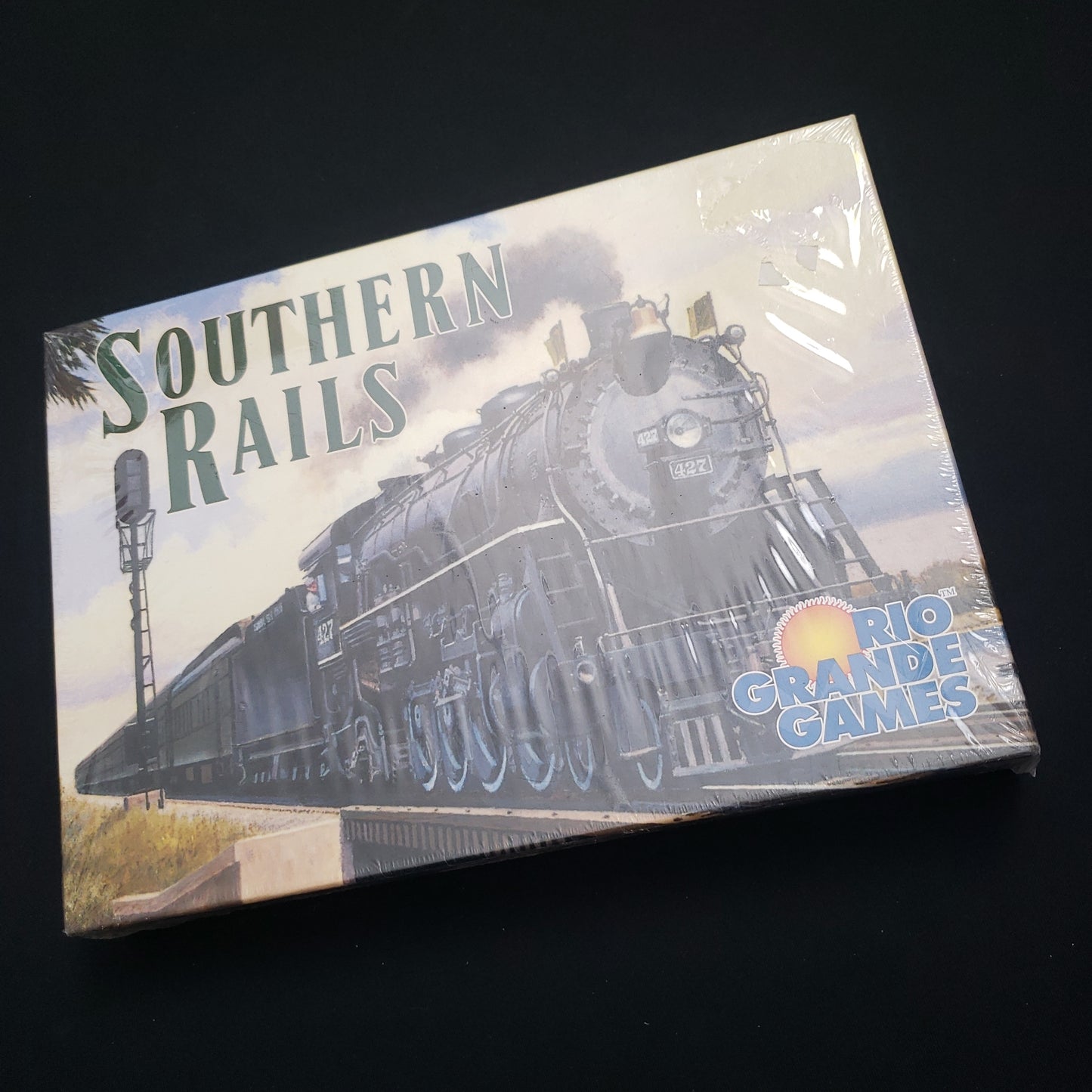 Image shows the front cover of the box of the Southern Rails board game