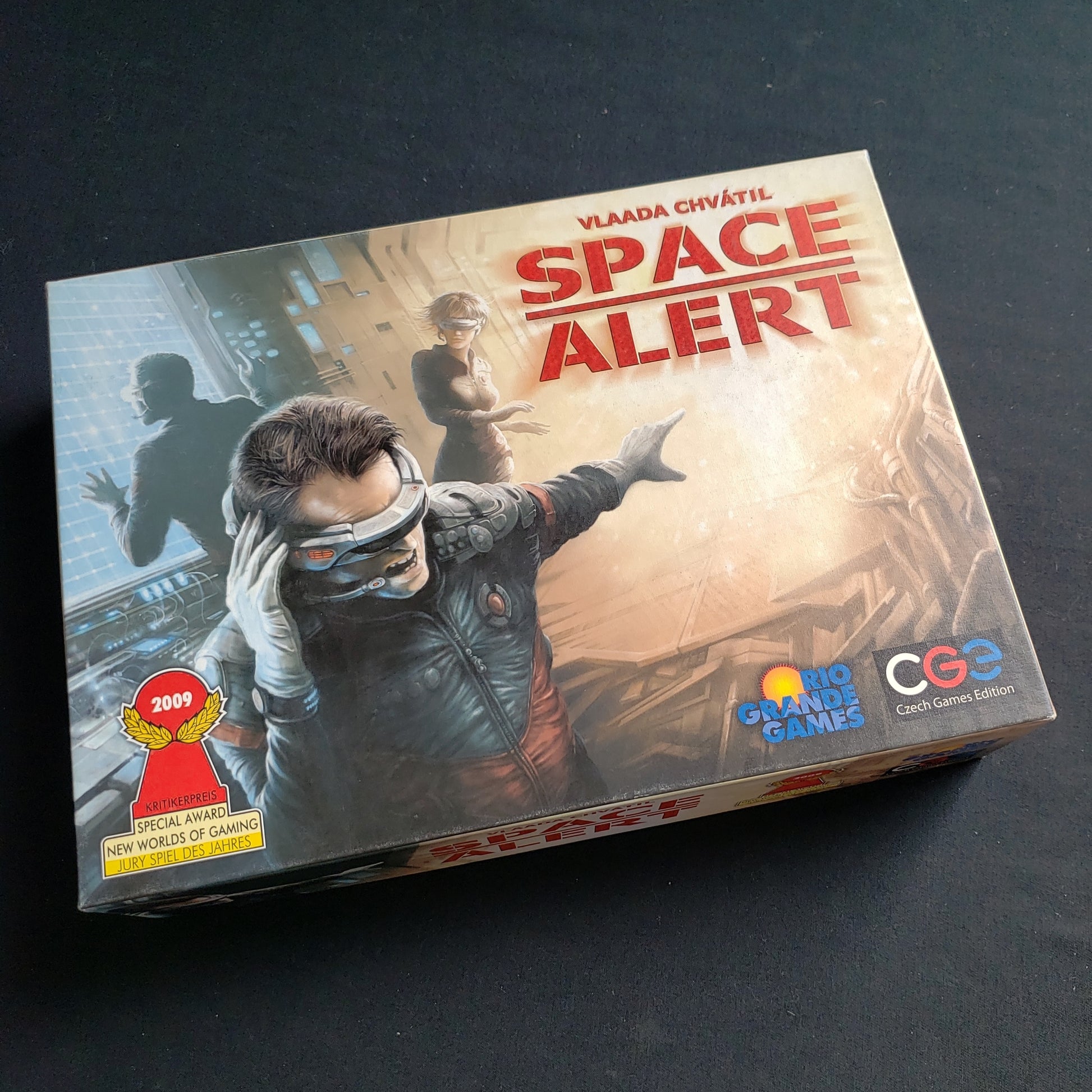 Image shows the front cover of the box of the Space Alert board game