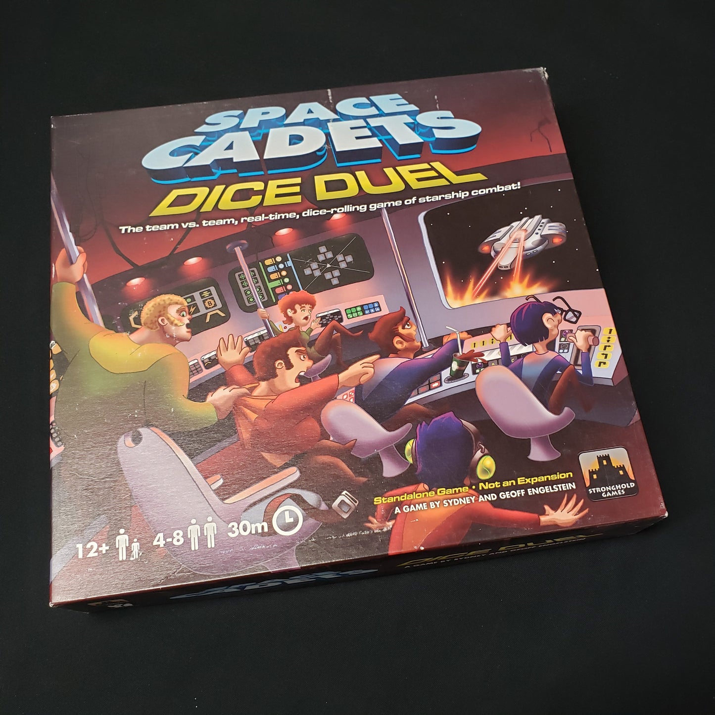 Image shows the front cover of the box of the Space Cadets: Dice Duel board game