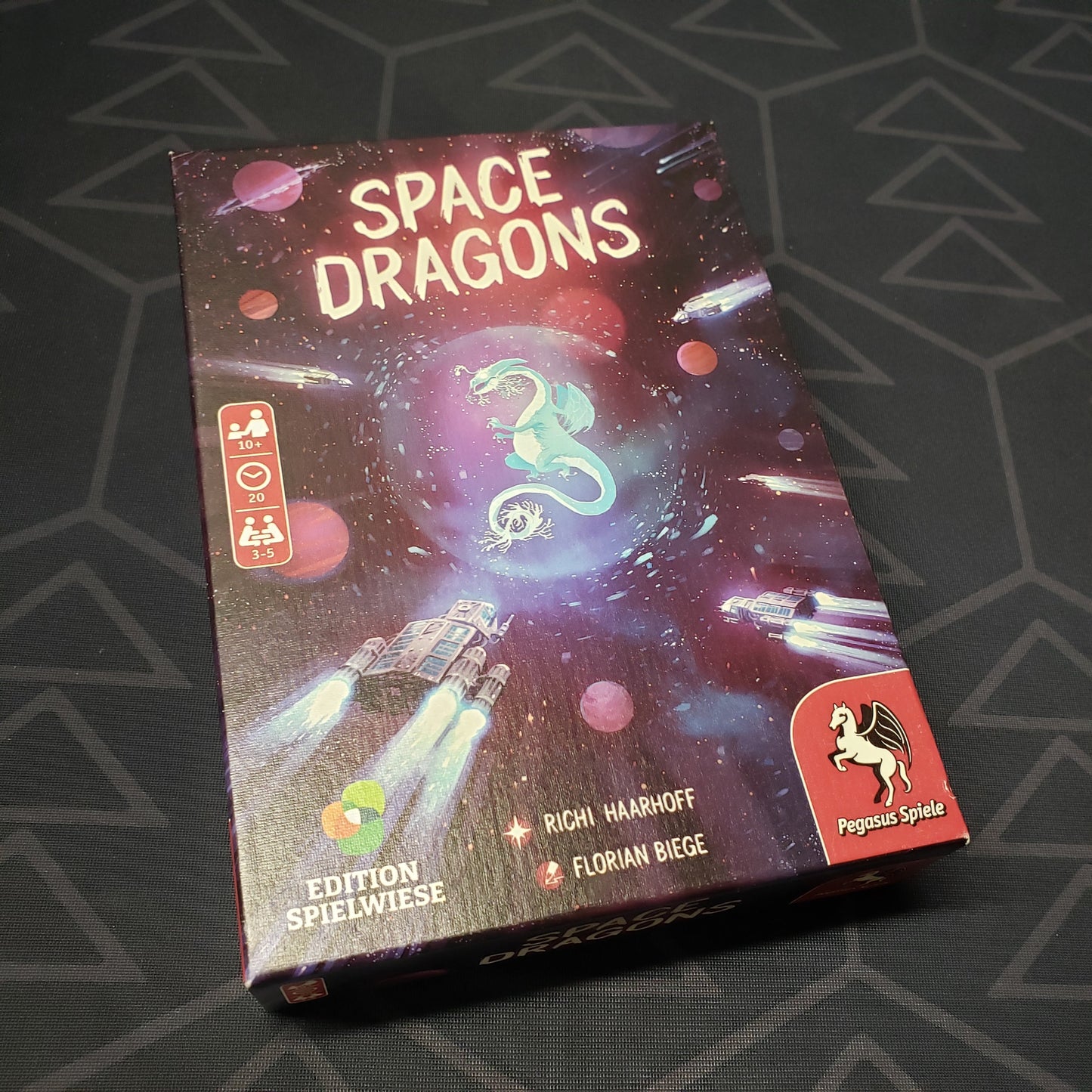Image shows the front cover of the box for the Space Dragons card game
