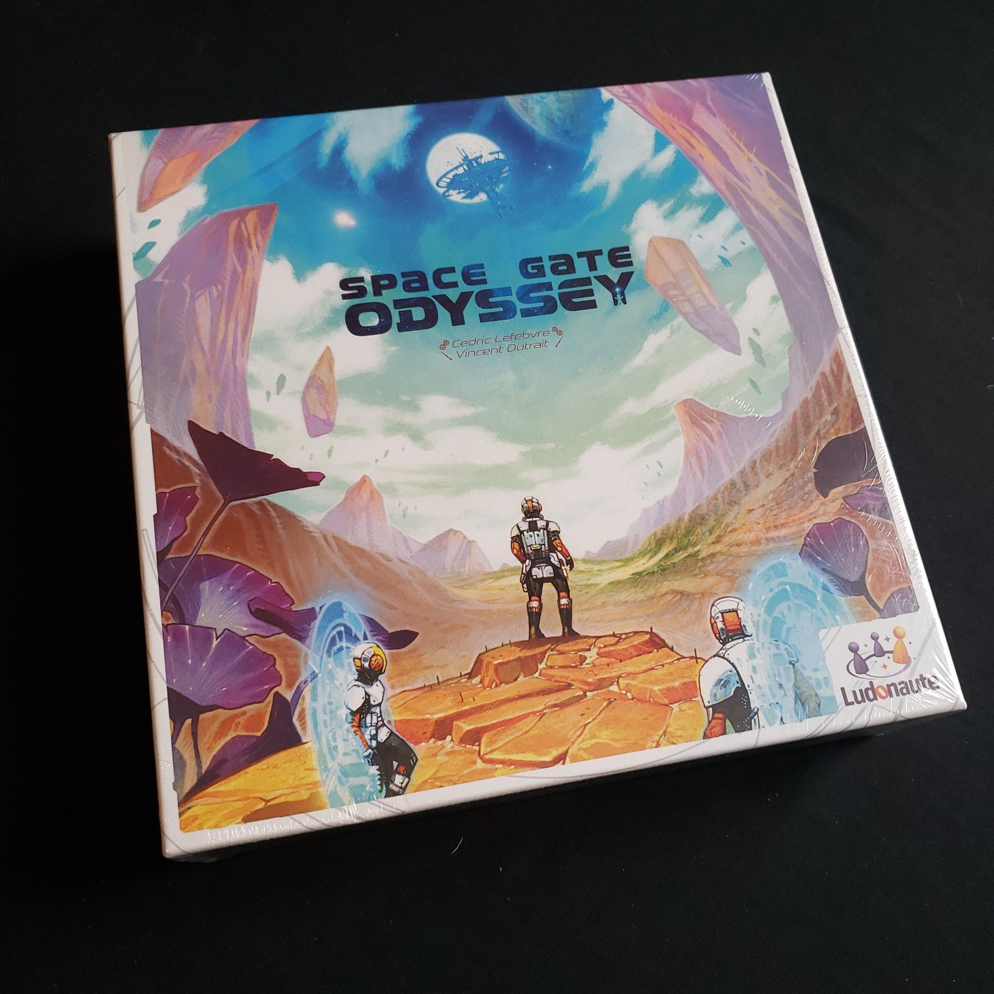 Image shows the front cover of the box of the Space Gate Odyssey board game