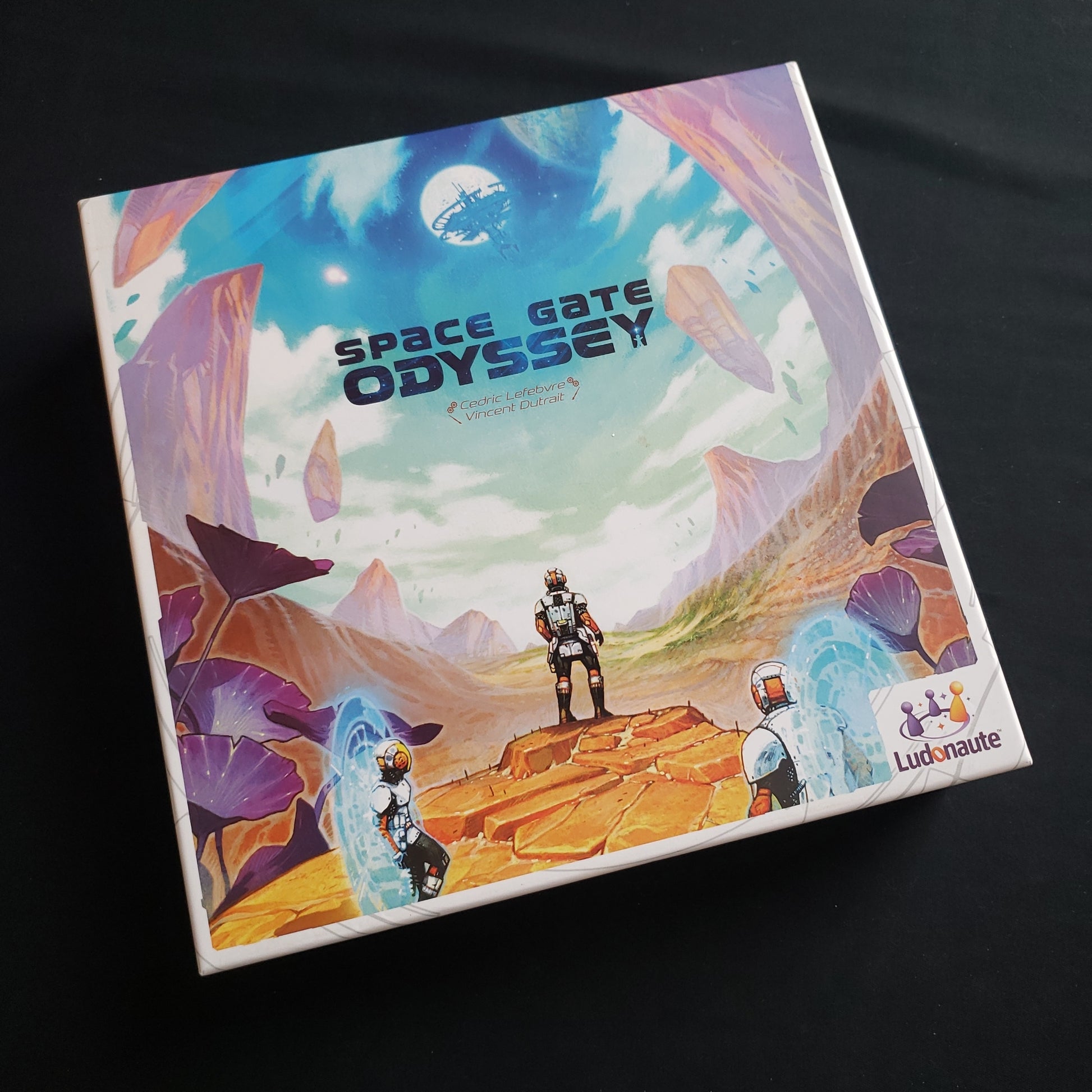 Image shows the front cover of the box of the Space Gate Odyssey board game