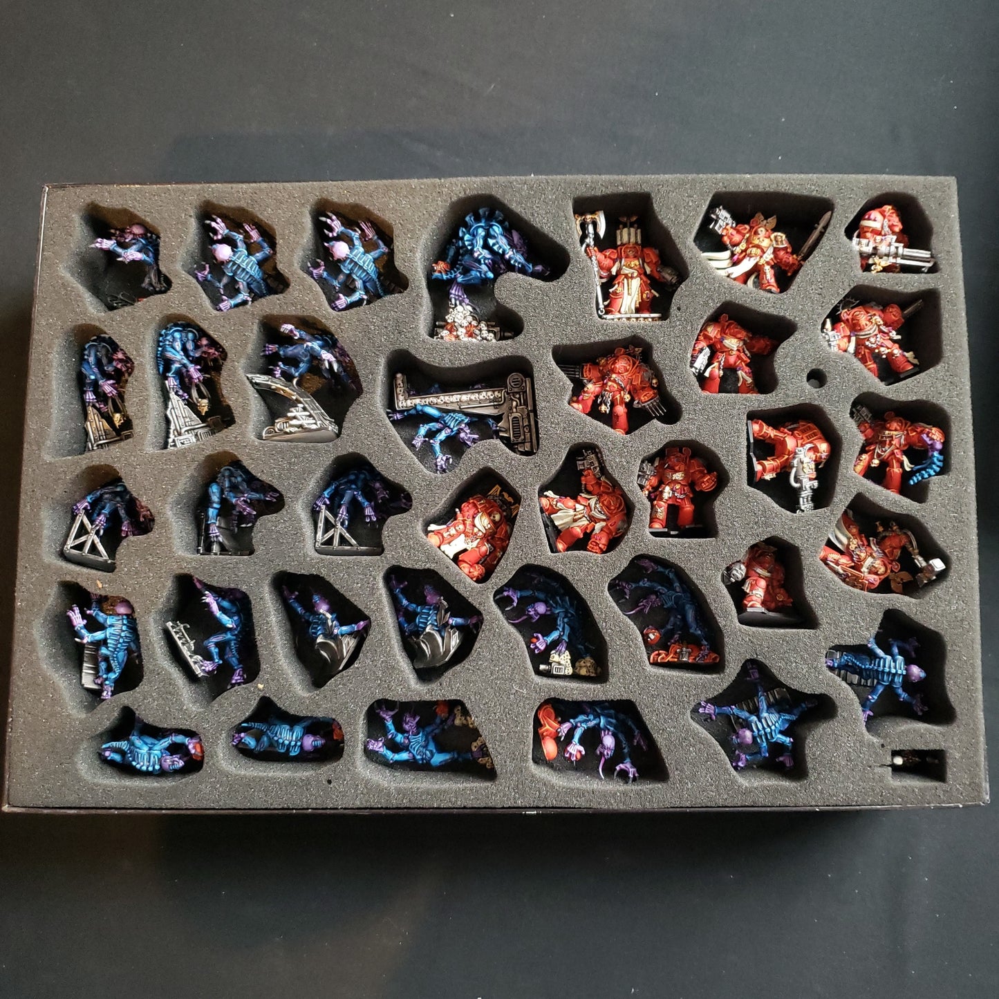 Image shows the the painted miniatures from the board game Space Hulk in a fitted foam box insert