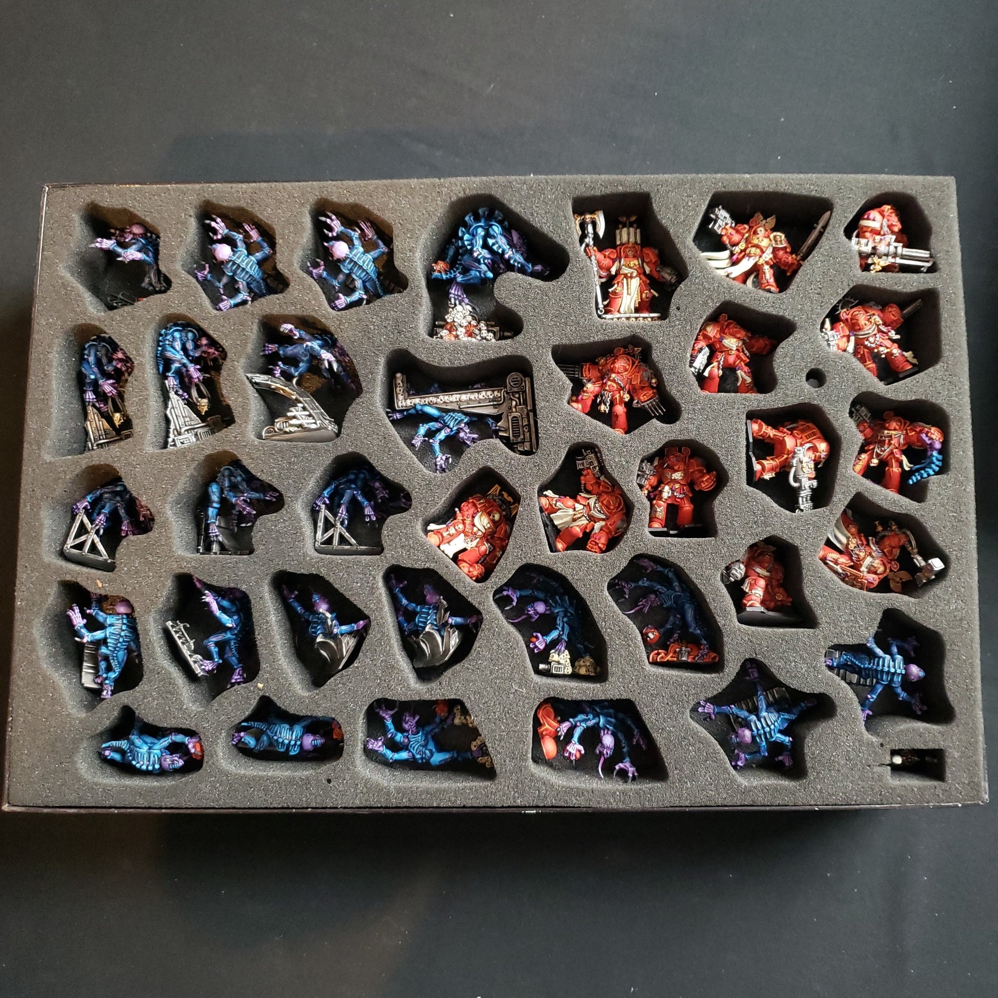 Image shows the the painted miniatures from the board game Space Hulk in a fitted foam box insert