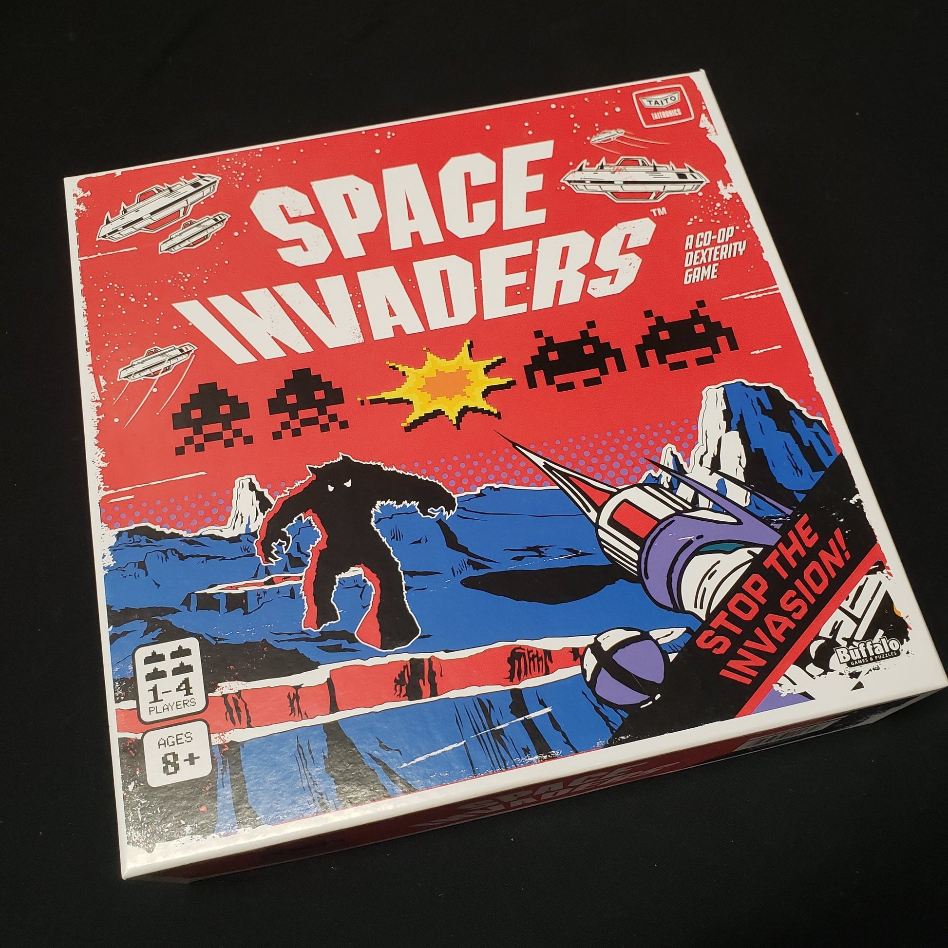Image shows the front cover of the box of the Space Invaders board game