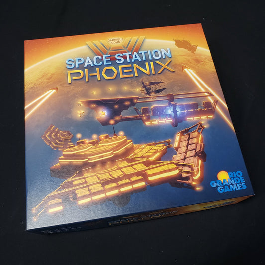 Image shows the front cover of the box of the Space Station Phoenix board game