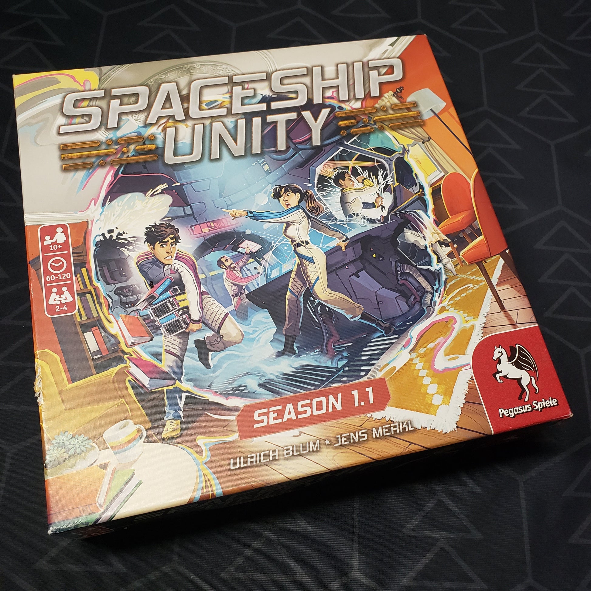 Image shows the front cover of the box for the Spaceship Unity: Season 1.1 board game