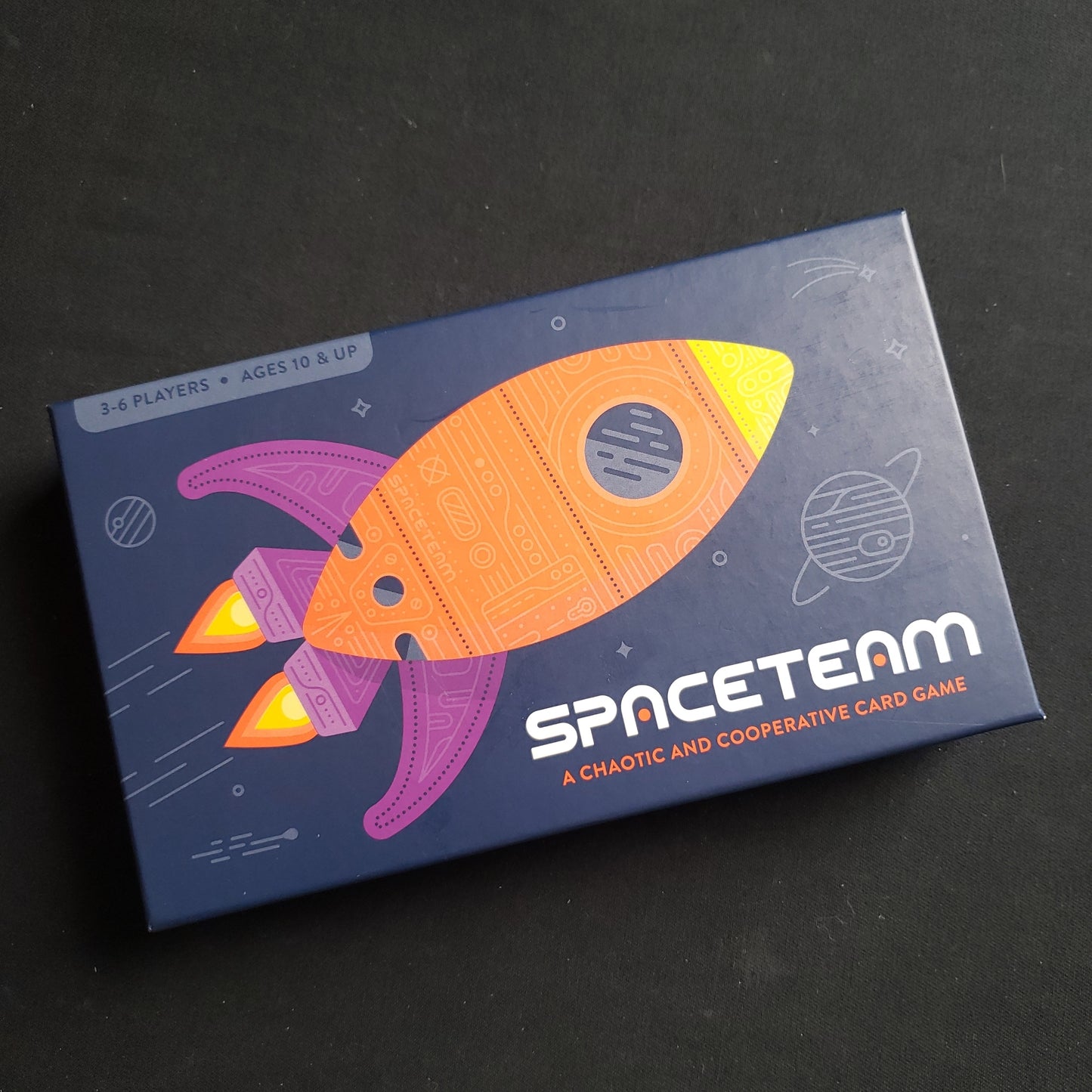 Image shows the front cover of the box of the Spaceteam card game