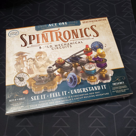 Image shows the front cover of the box of the Spintronics: Act One STEM puzzle game