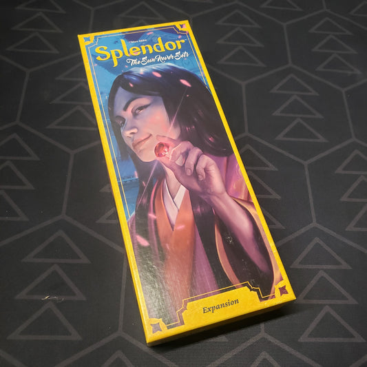 Image shows the front cover of the box of the Sun Never Sets expansion for the board game Splendor