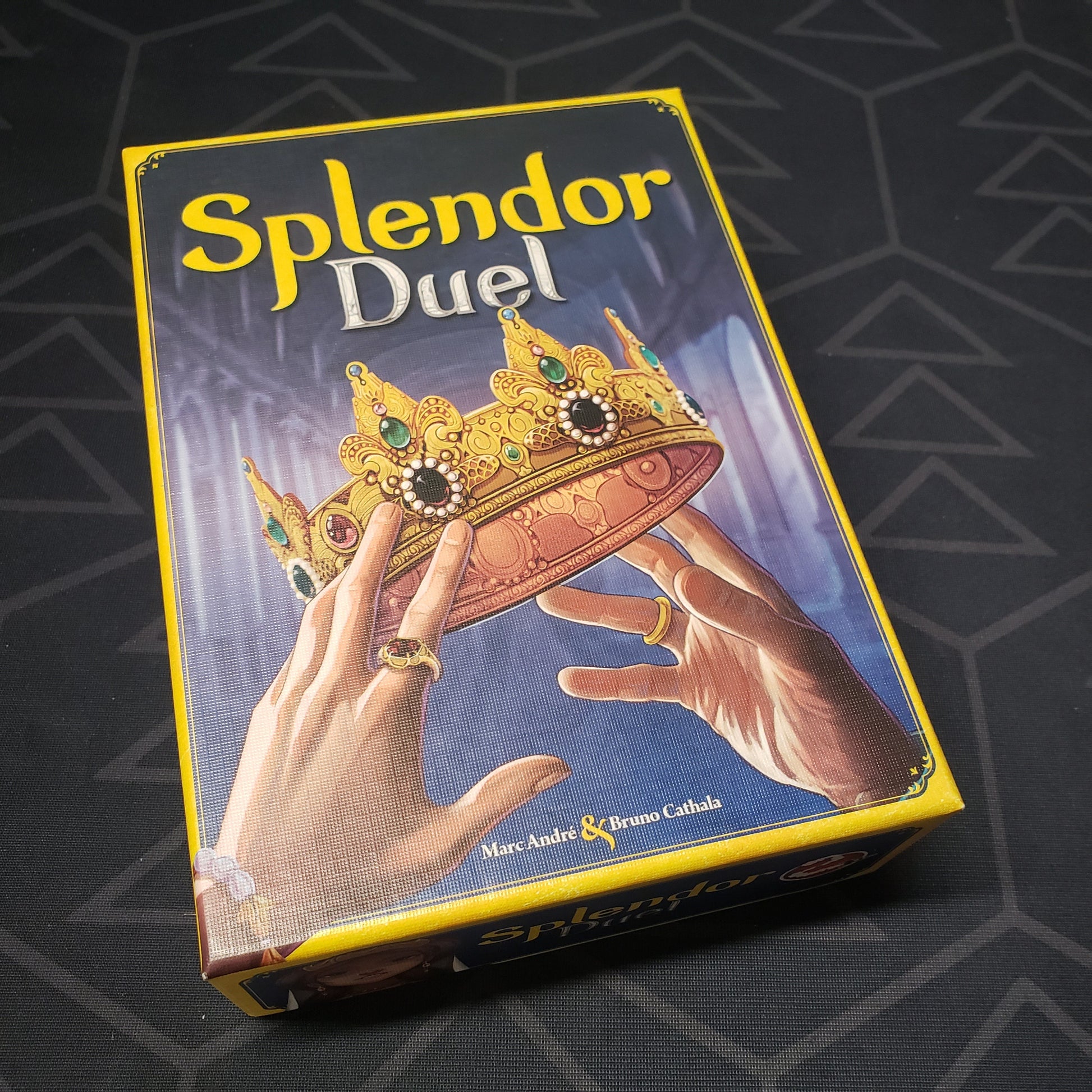 Image shows the front cover of the box of the Splendor Duel board game