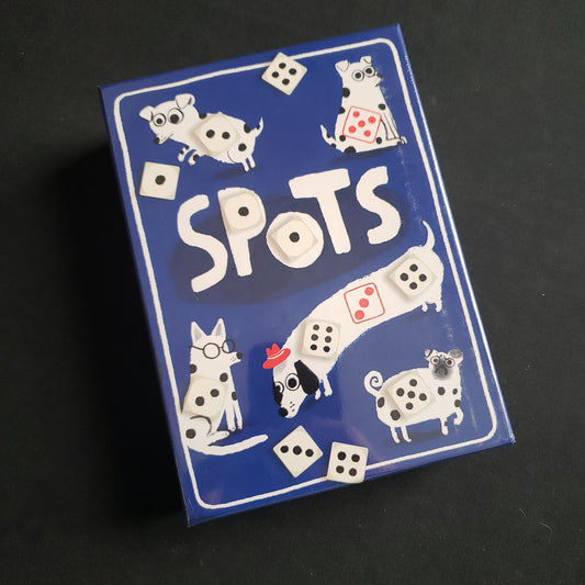 Image shows the front cover of the box of the Spots board game