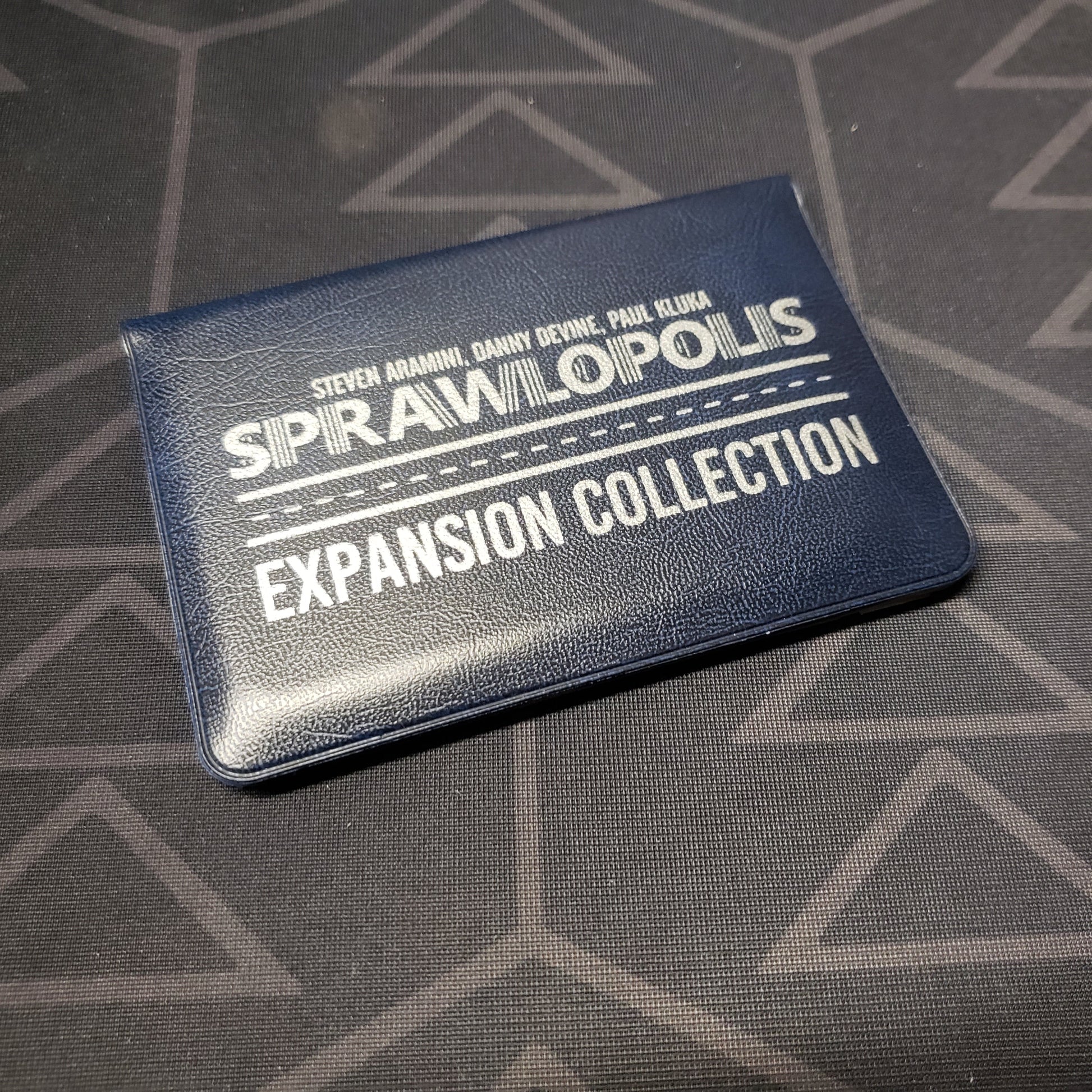 Image shows the front of the card wallet of the Expansion Collection for the card game Sprawlopolis