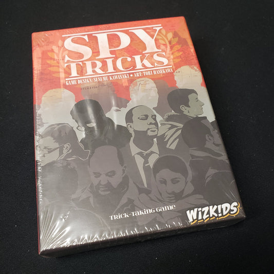 Image shows the front cover of the box of the Spy Tricks card game