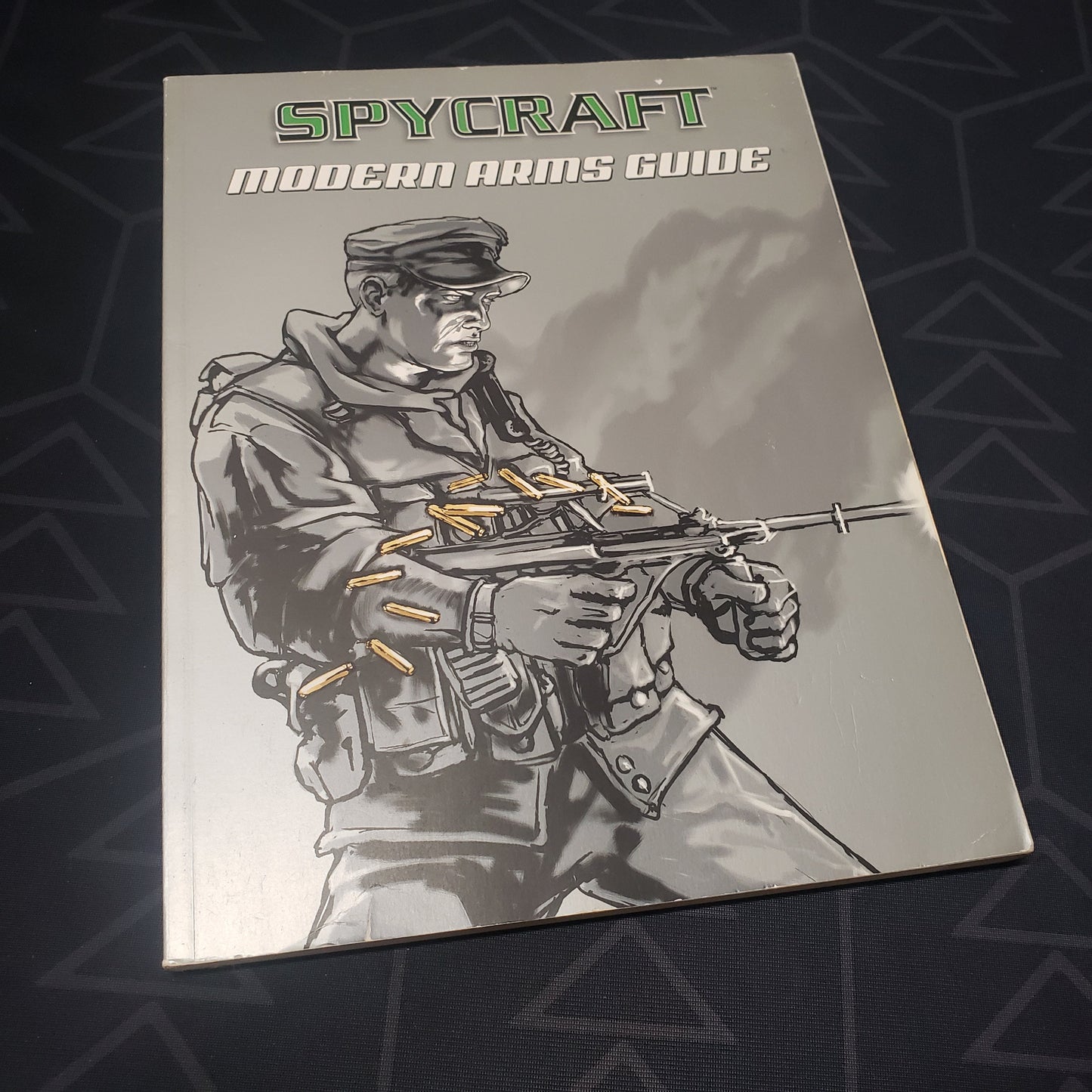 Image shows the front cover of the Modern Arms Guide book for the roleplaying game Spycraft