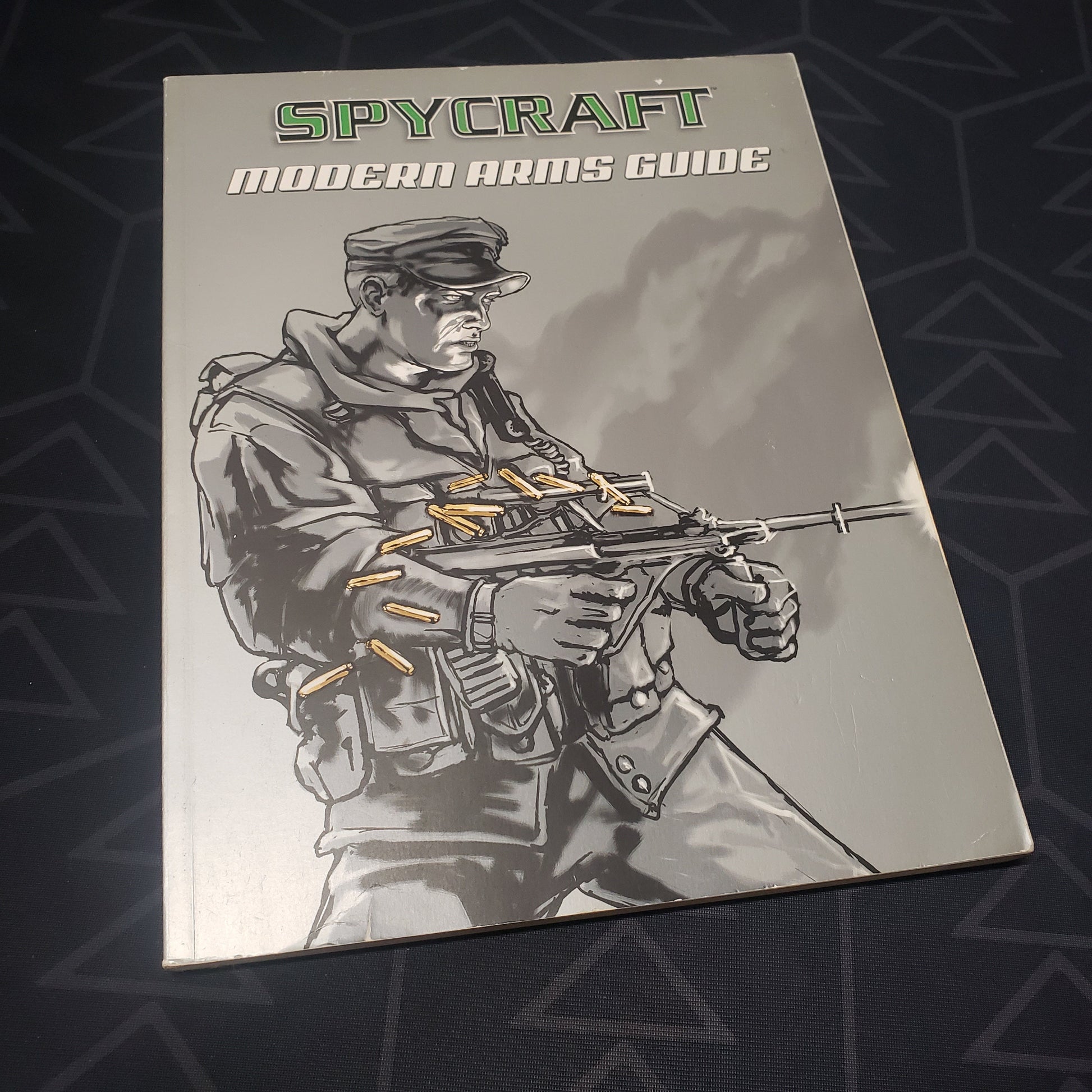 Image shows the front cover of the Modern Arms Guide book for the roleplaying game Spycraft