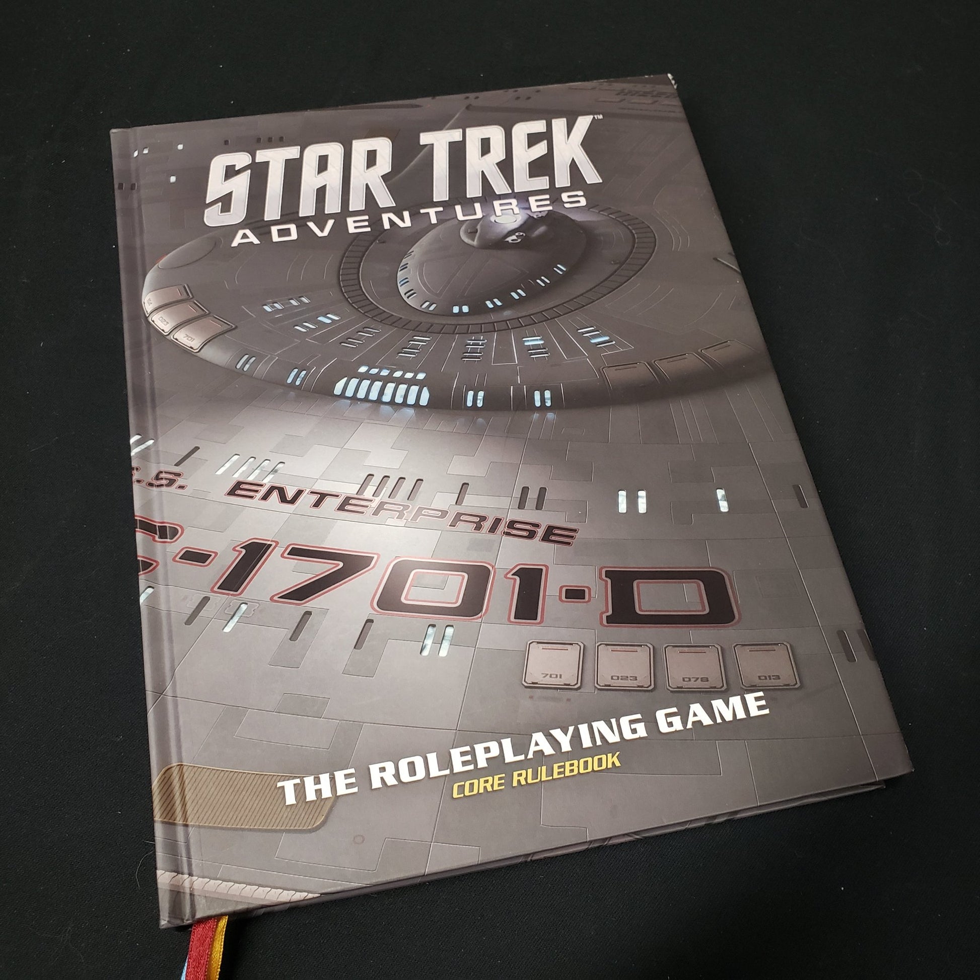 Image shows the front cover of the collector's edition core rulebook for the roleplaying game Star Trek Adventures
