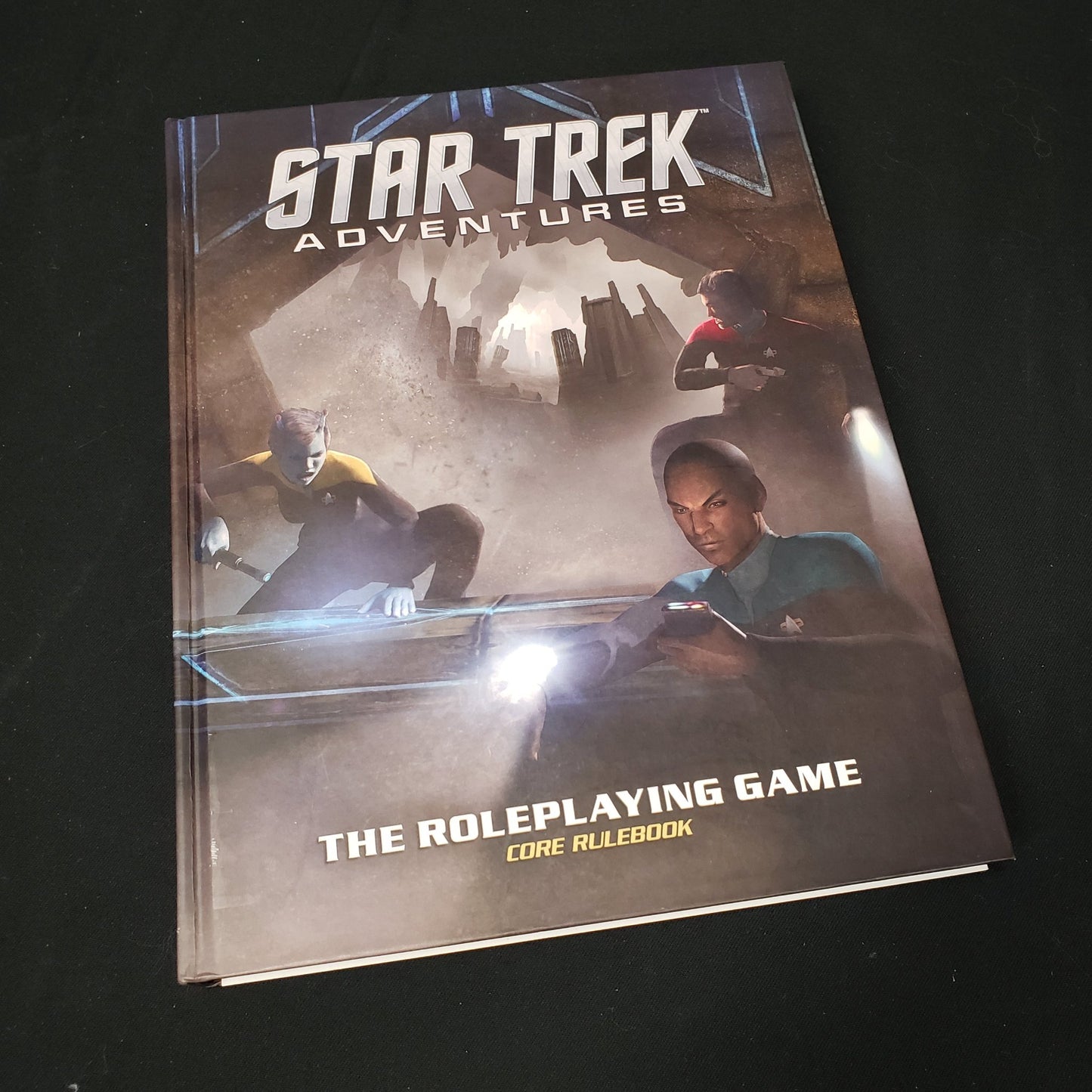 Image shows the front cover of the core rulebook for the roleplaying game Star Trek Adventures