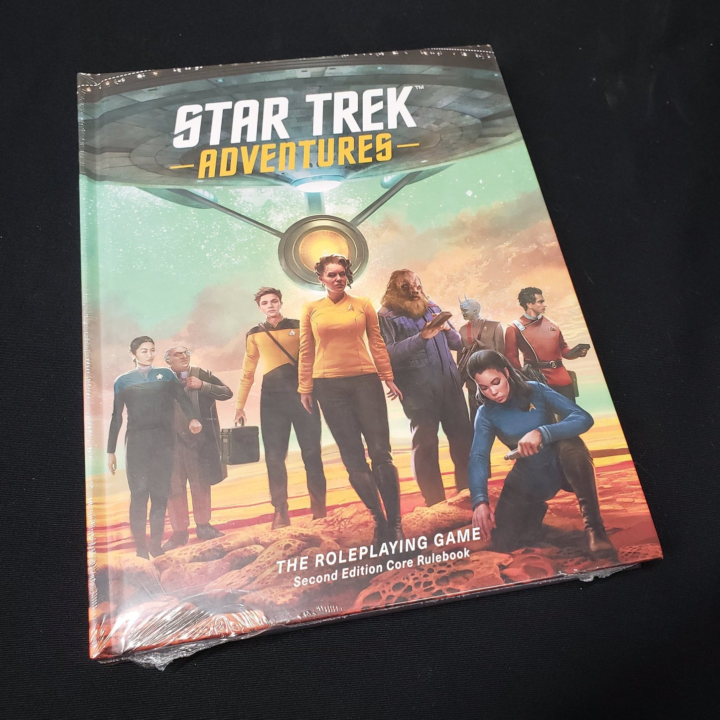 Image shows the front cover of the second edition core rulebook for the Star trek Adventures roleplaying game