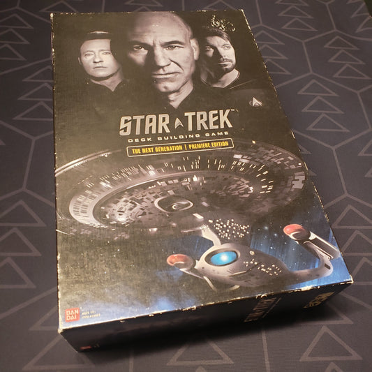 Image shows the front cover of the box of the card game Star Trek Deck Building Game: The Next Generation