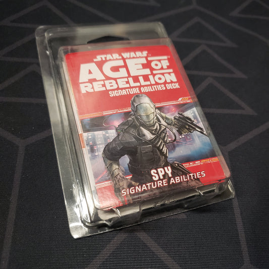 Image shows the front of the clamshell packaging for the Spy Signature Abilities Deck for the roleplaying game Star Wars: Age of Rebellion