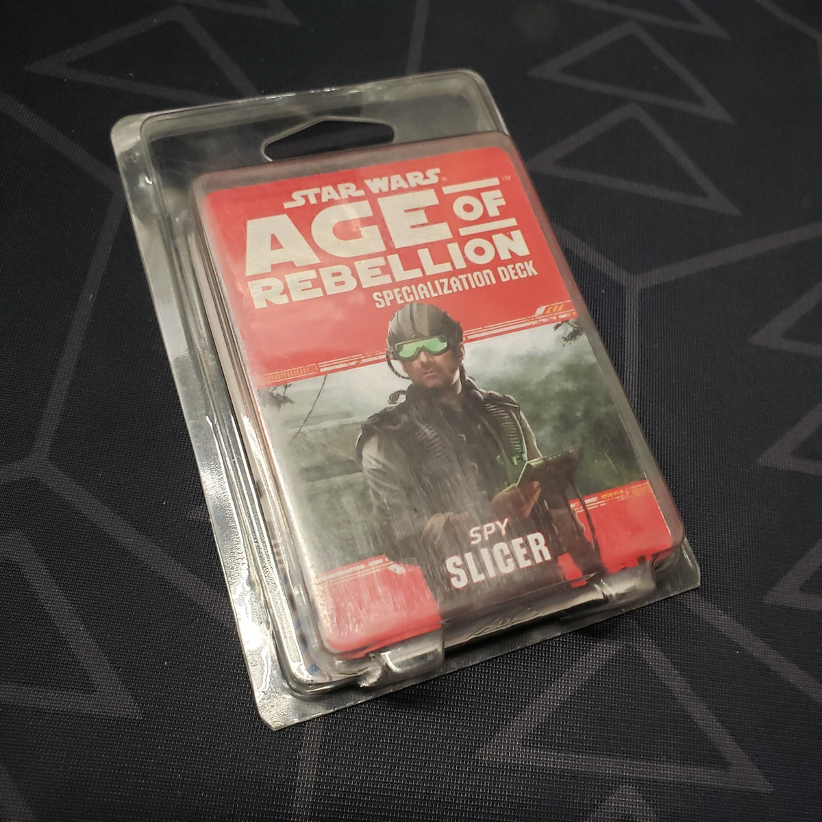 Image shows the front of the clamshell packaging for the Spy Slicer Deck for the roleplaying game Star Wars: Age of Rebellion