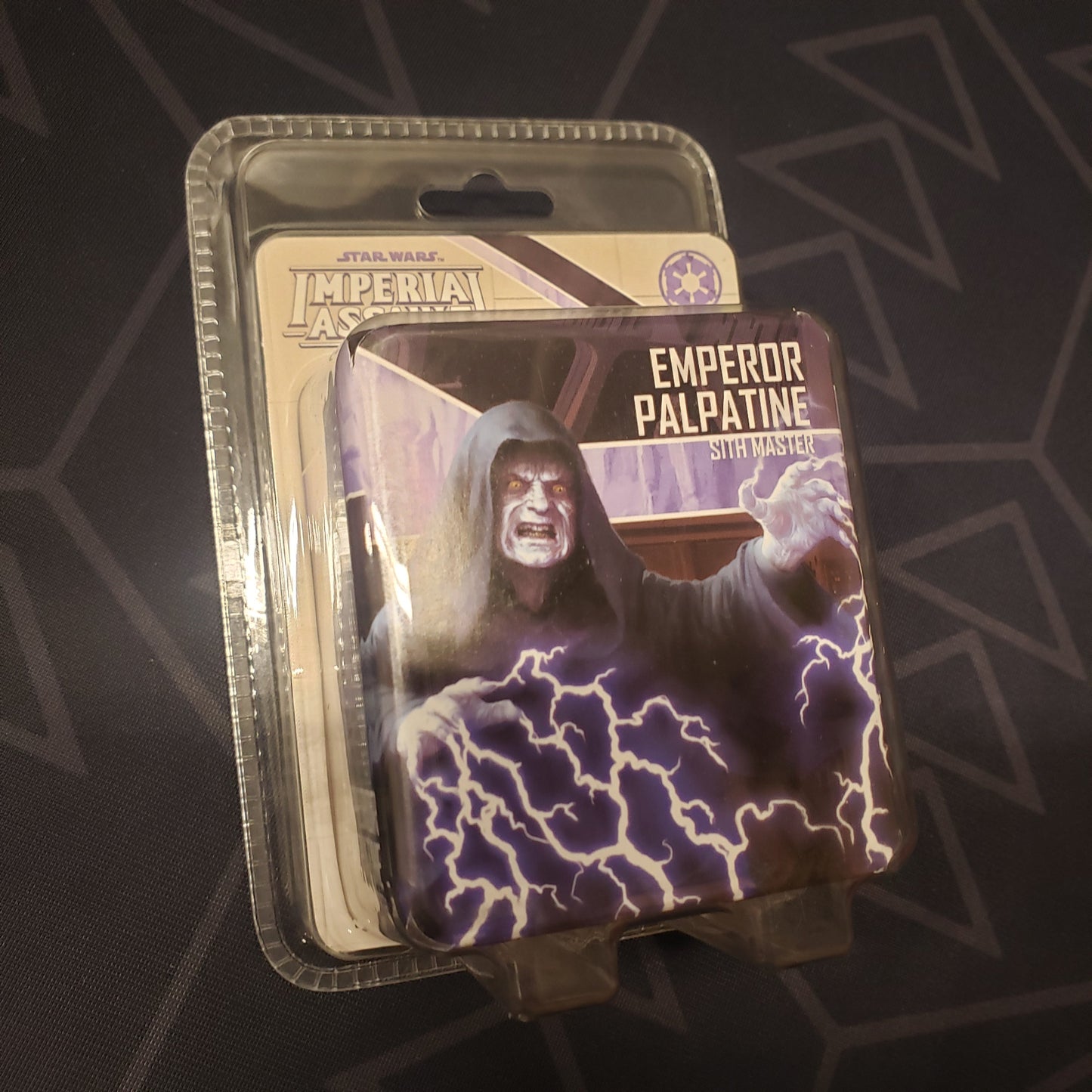 Image shows the front of the package for the Emperor Palpatine Pack expansion for the board game Star Wars: Imperial Assault