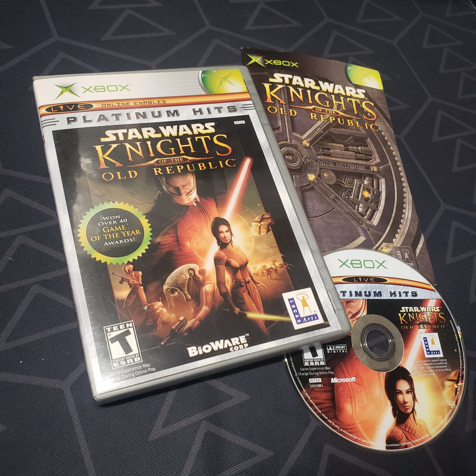 Image shows the case, manual and disc for the video game Star Wars: Knights of the Old Republic for the original Xbox