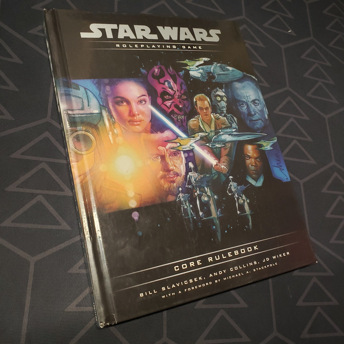 Image shows the front cover of the 2000 core rulebook for the roleplaying game Star Wars Roleplaying Game