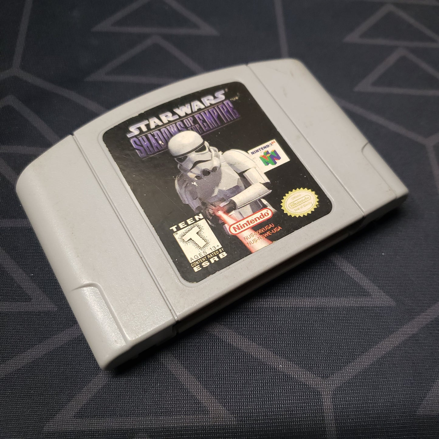 Image shows the front of the cartridge for the video game Star Wars: Shadows of the Empire for the Nintendo 64