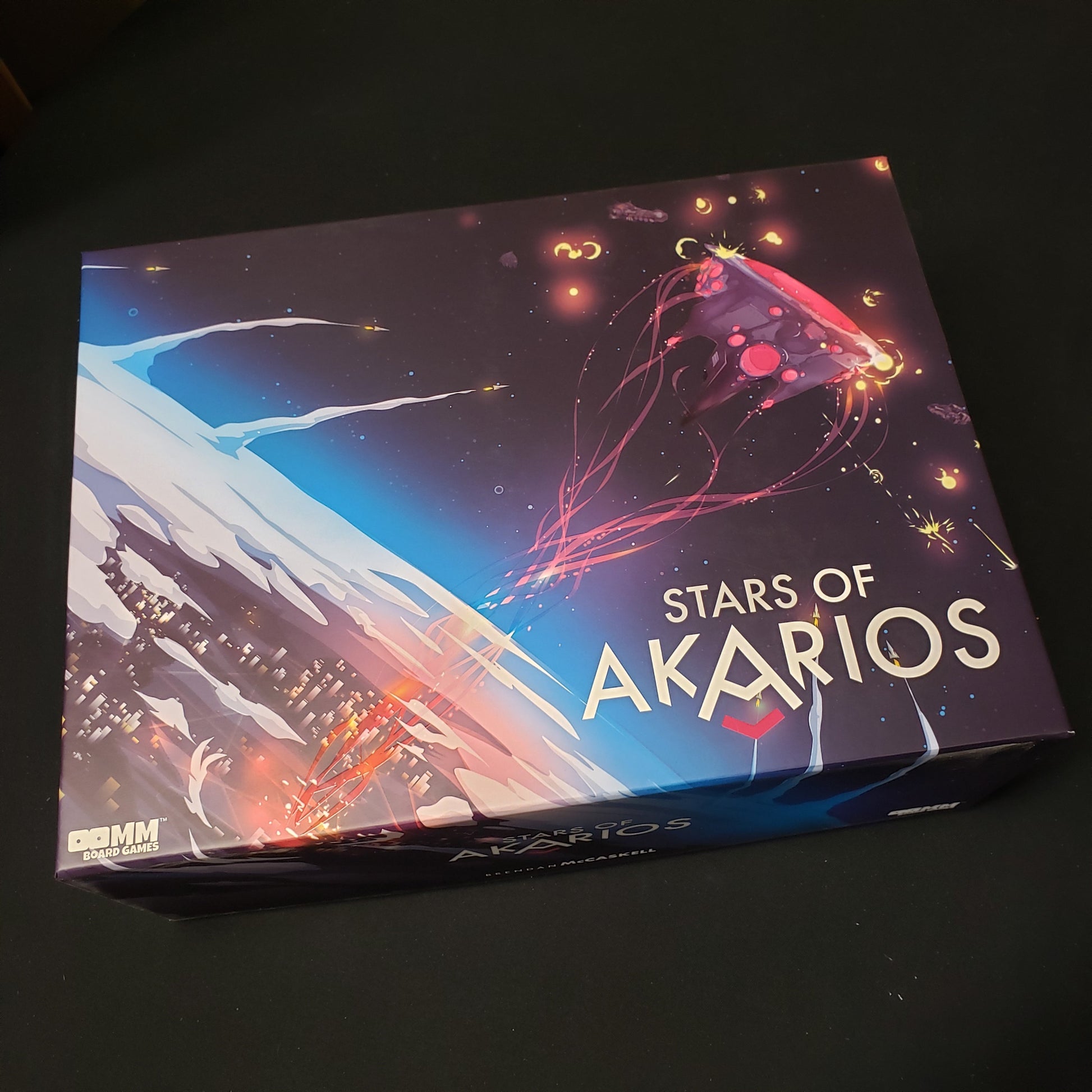 Image shows the front cover of the box of the Stars of Akarios board game