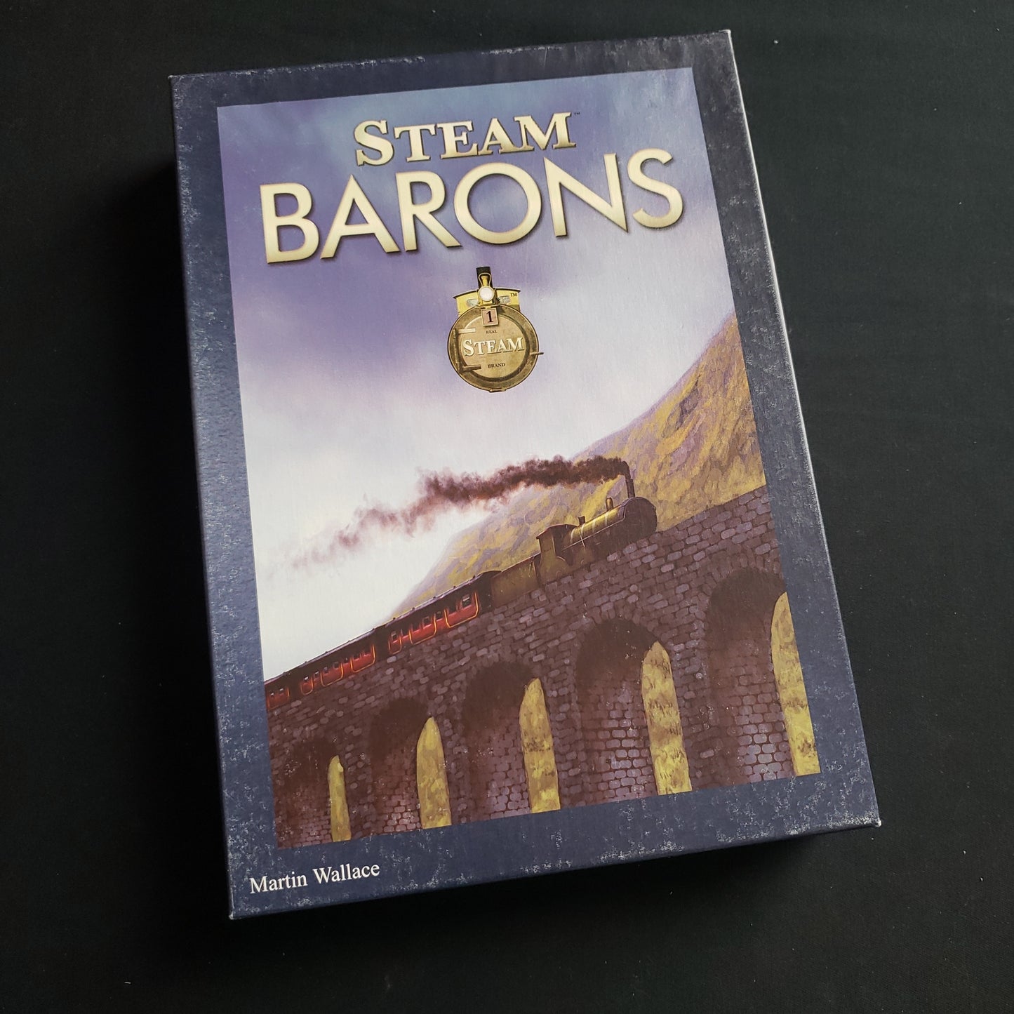 Image shows the front cover of the box of the Steam Barons expansion for the Steam board game