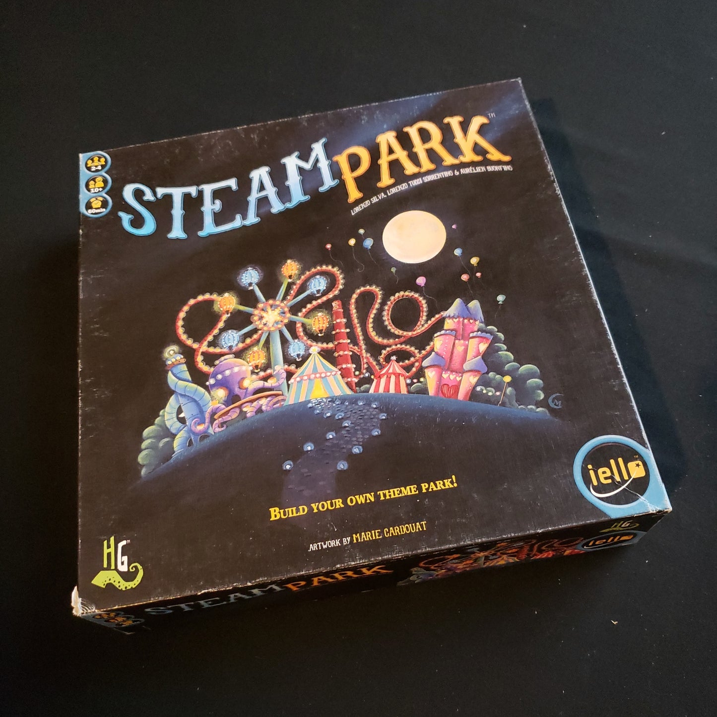 Image shows the front cover of the box of the Steam Park board game