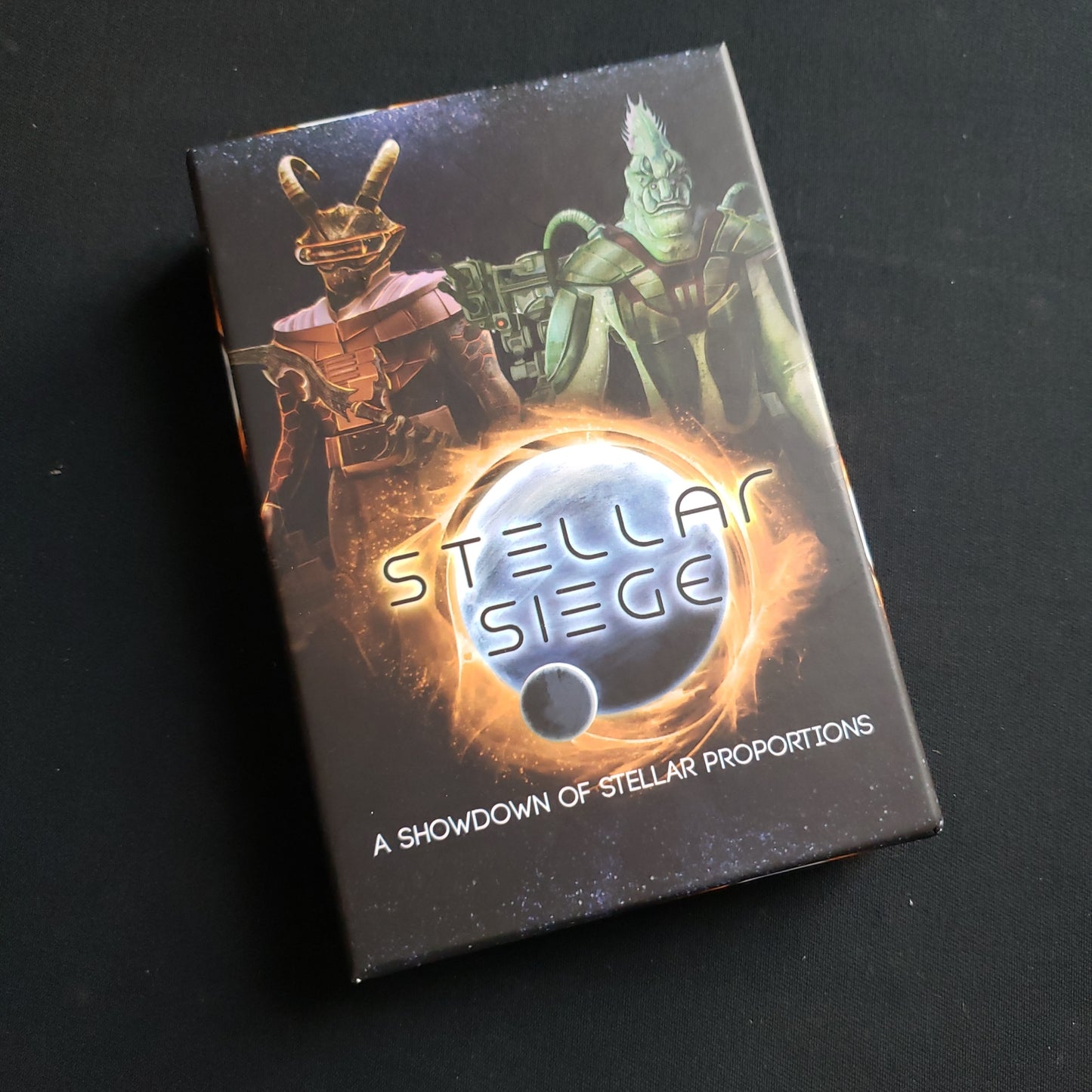 Image shows the front cover of the box of the Stellar Siege card game