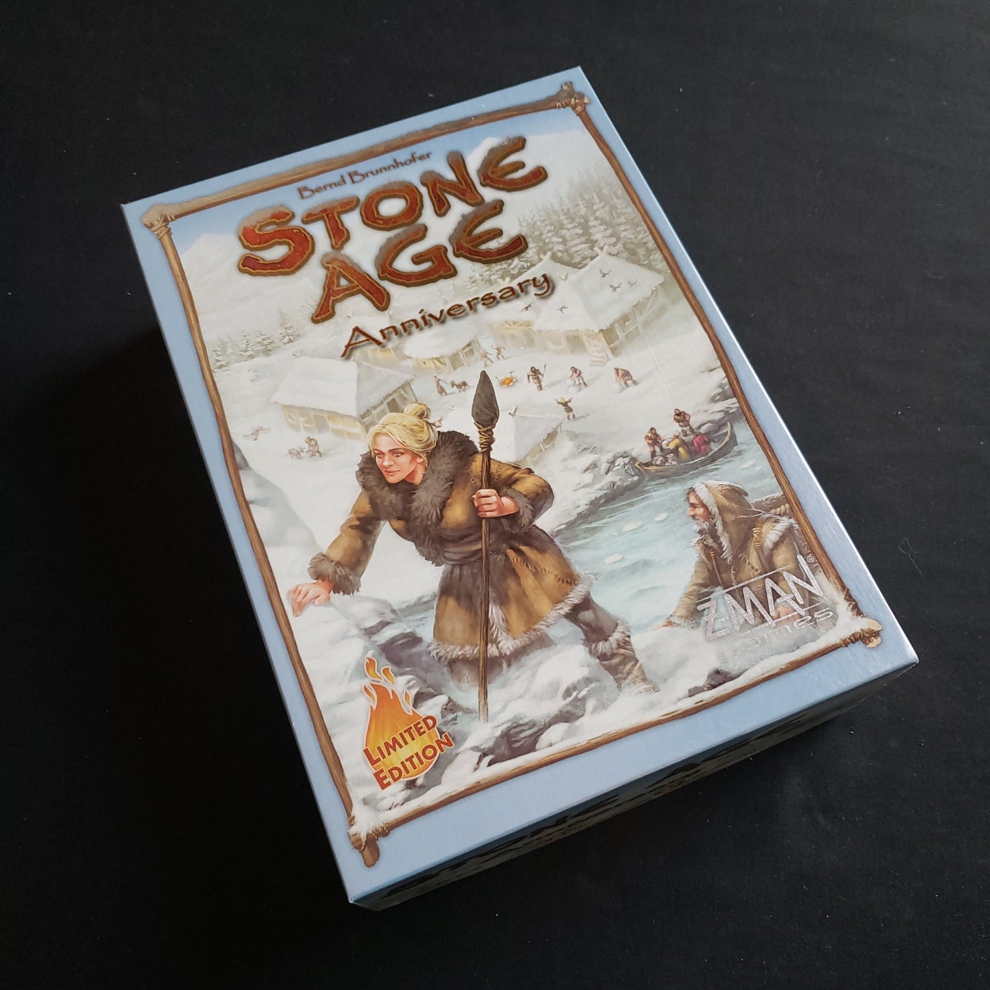 Image shows the front cover of the box of the Stone Age: Anniversary Edition board game