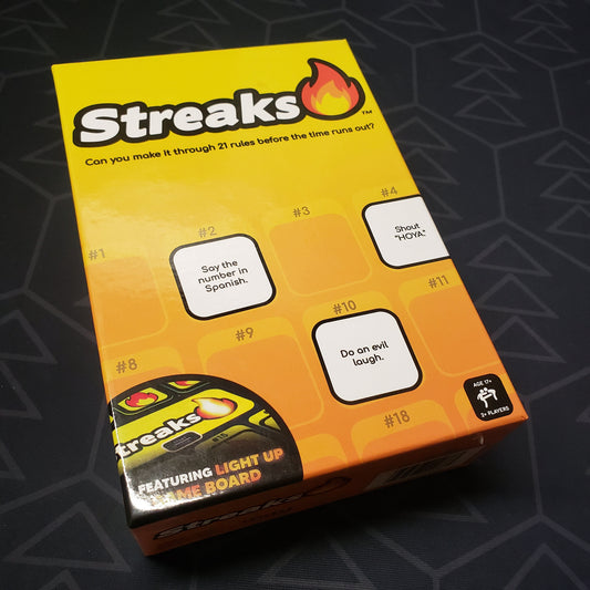 Image shows the front cover of the box for the Streaks board game