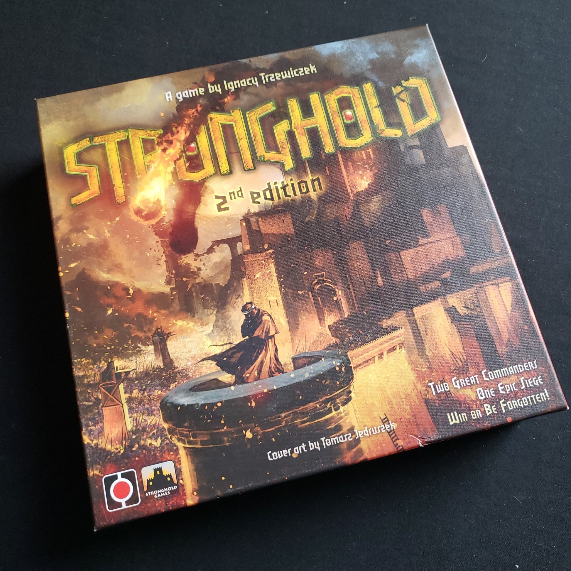 Image shows the front cover of the box of the Stronghold: Second Edition board game