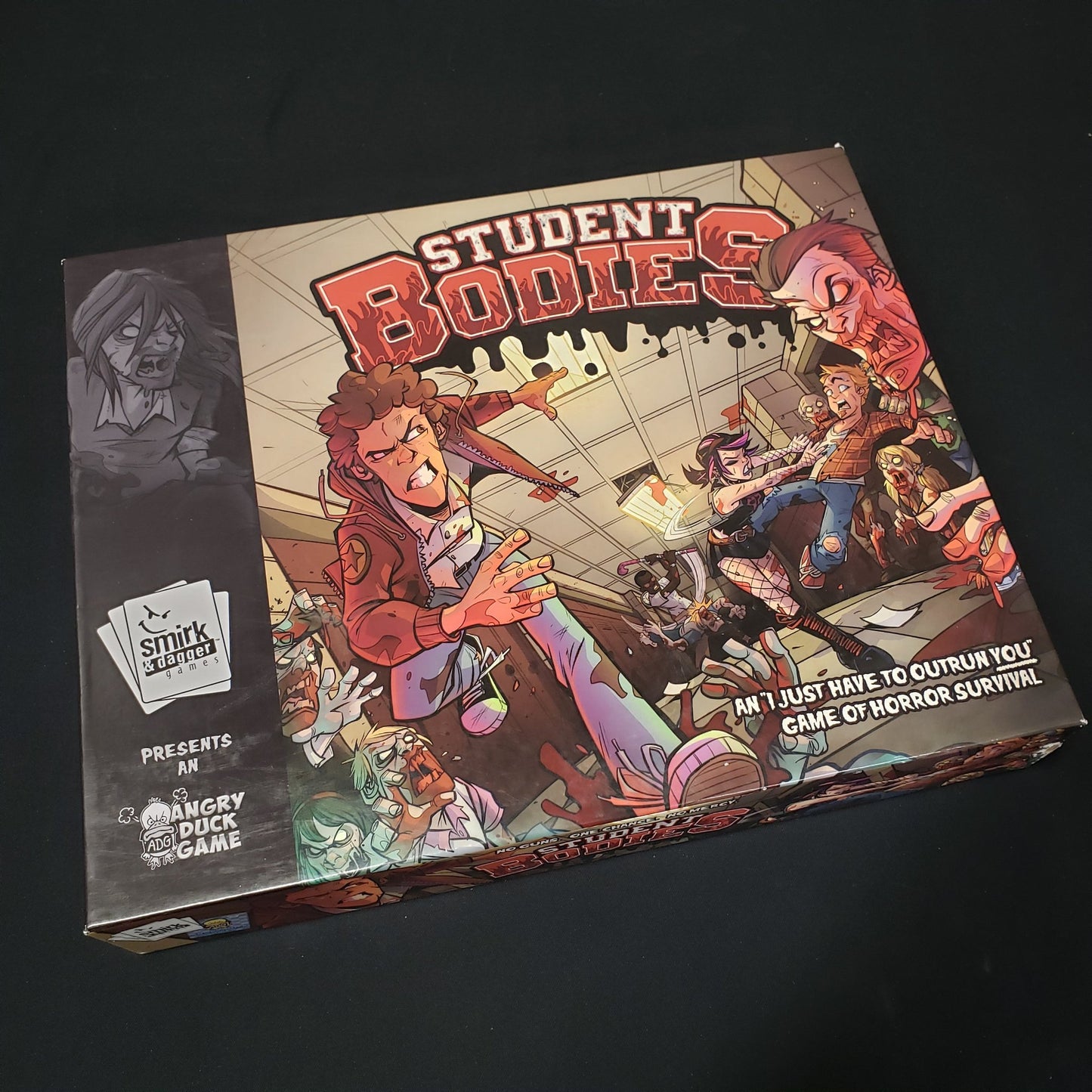 Image shows the front cover of the box of the Student Bodies board game