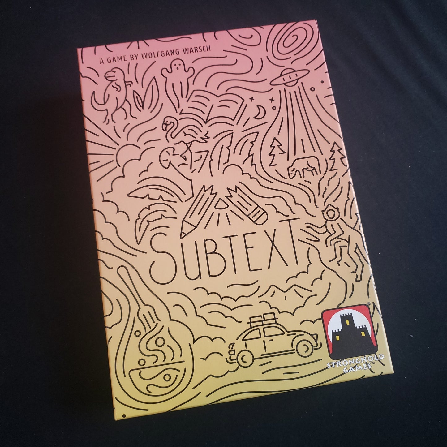 Image shows the front cover of the box of the Subtext party game