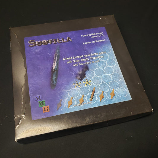 Image shows the front cover of the box of the Subtilla board game