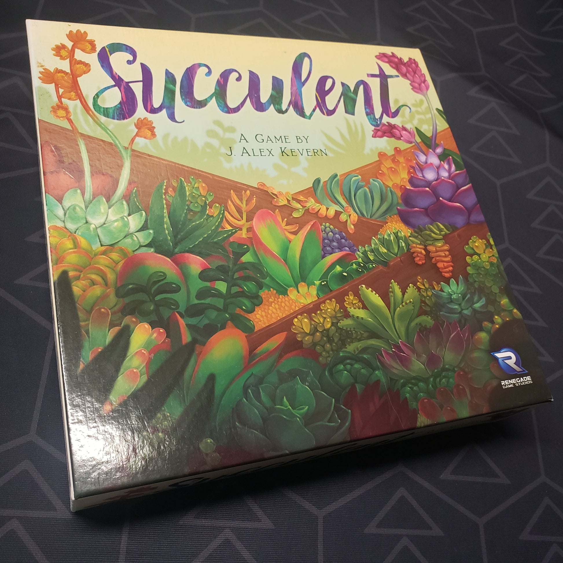 Image shows the front cover of the box for the Succulent board game
