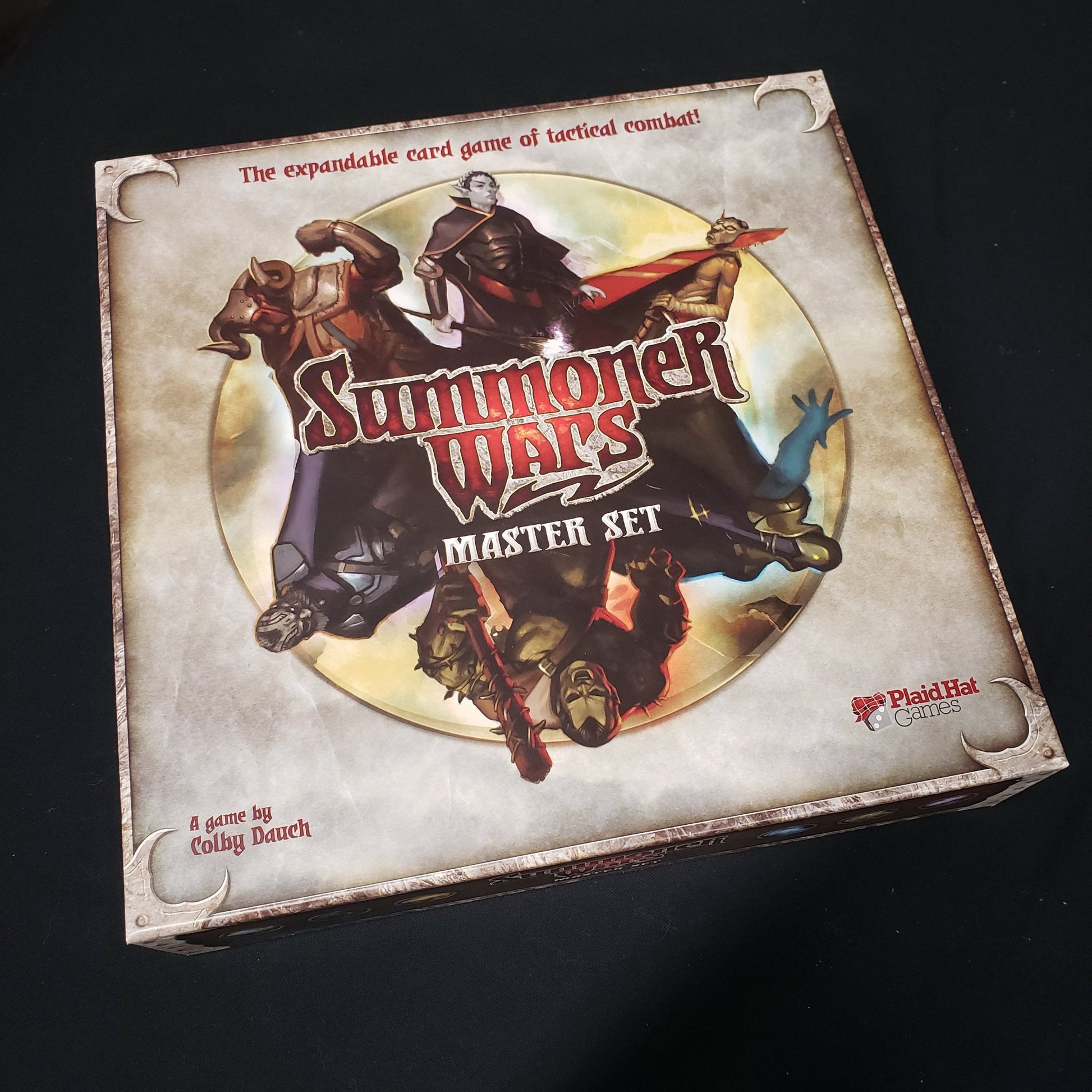 Image shows the front cover of the box of the first edition Master Set for the Summoner Wars coard game