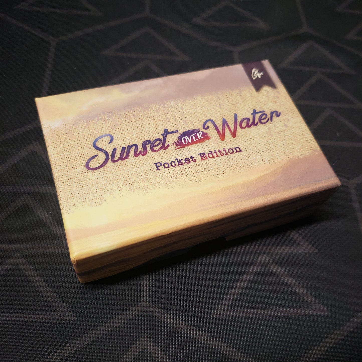 Image shows the front cover of the box for the Sunset Over Water: Pocket Edition card game