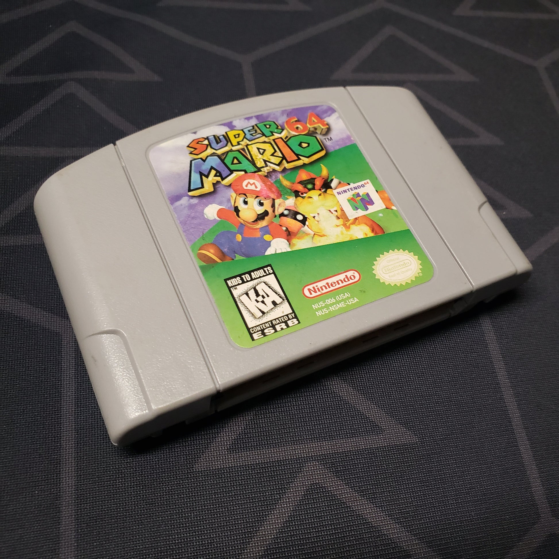 Image shows the front of the cartridge for the video game Super Mario 64 for the Nintendo 64