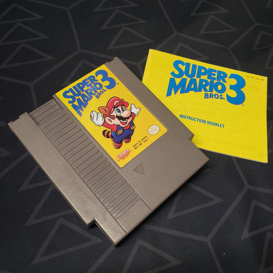 Image shows the front of the cartridge & the manual for the video game Super Mario Bros. 3 for the Nintendo Entertainment System