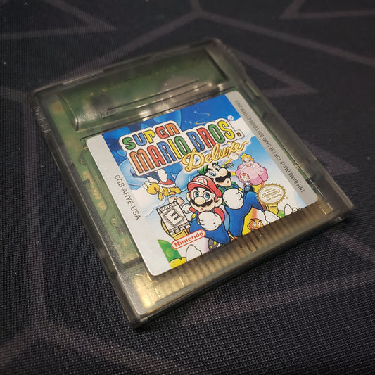 Image shows the front of the cartridge for the video game Super Mario Bros. Deluxe for Nintendo Game Boy Color