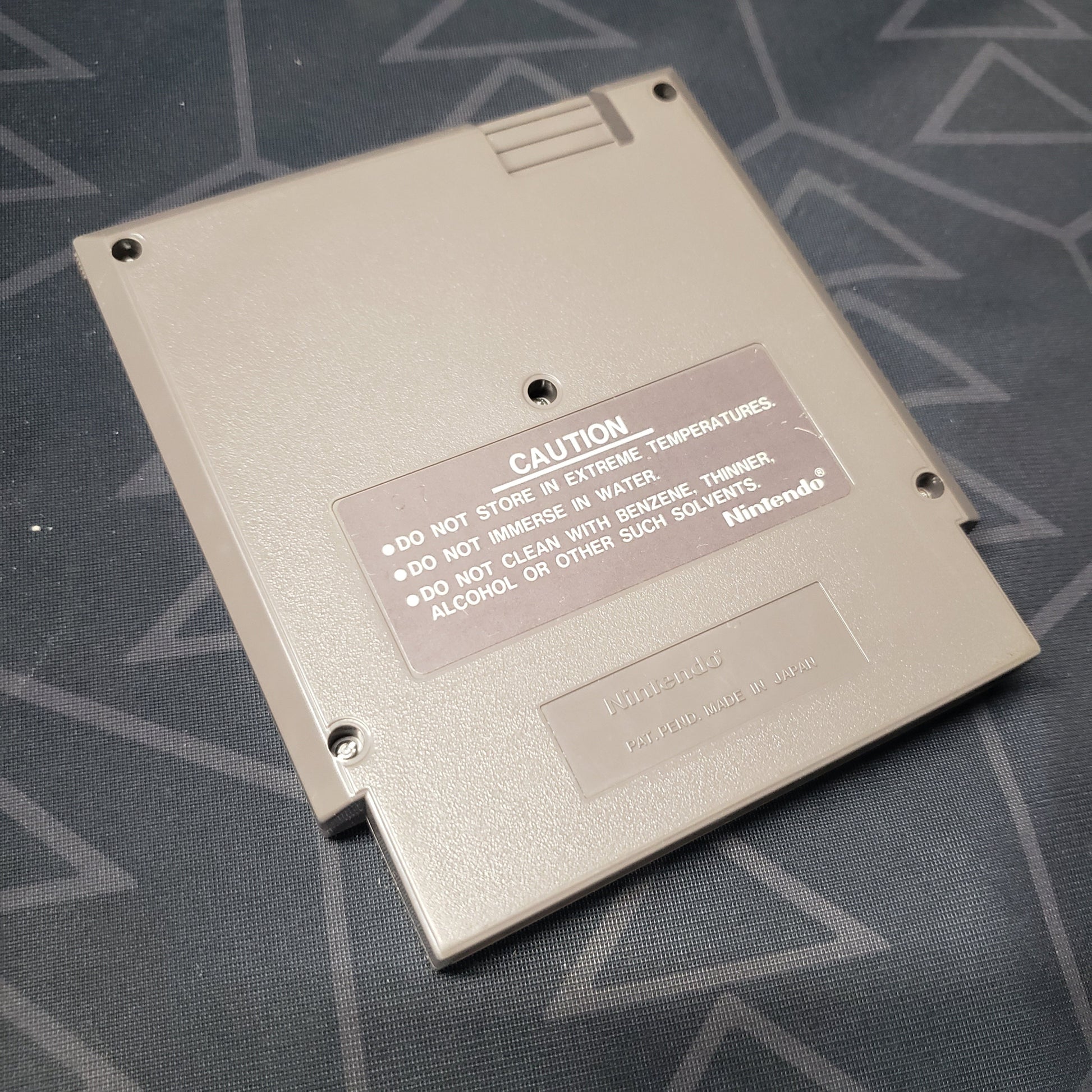 Image shows the back of the cartridge for the video game Super Mario Bros. for the Nintendo Entertainment System